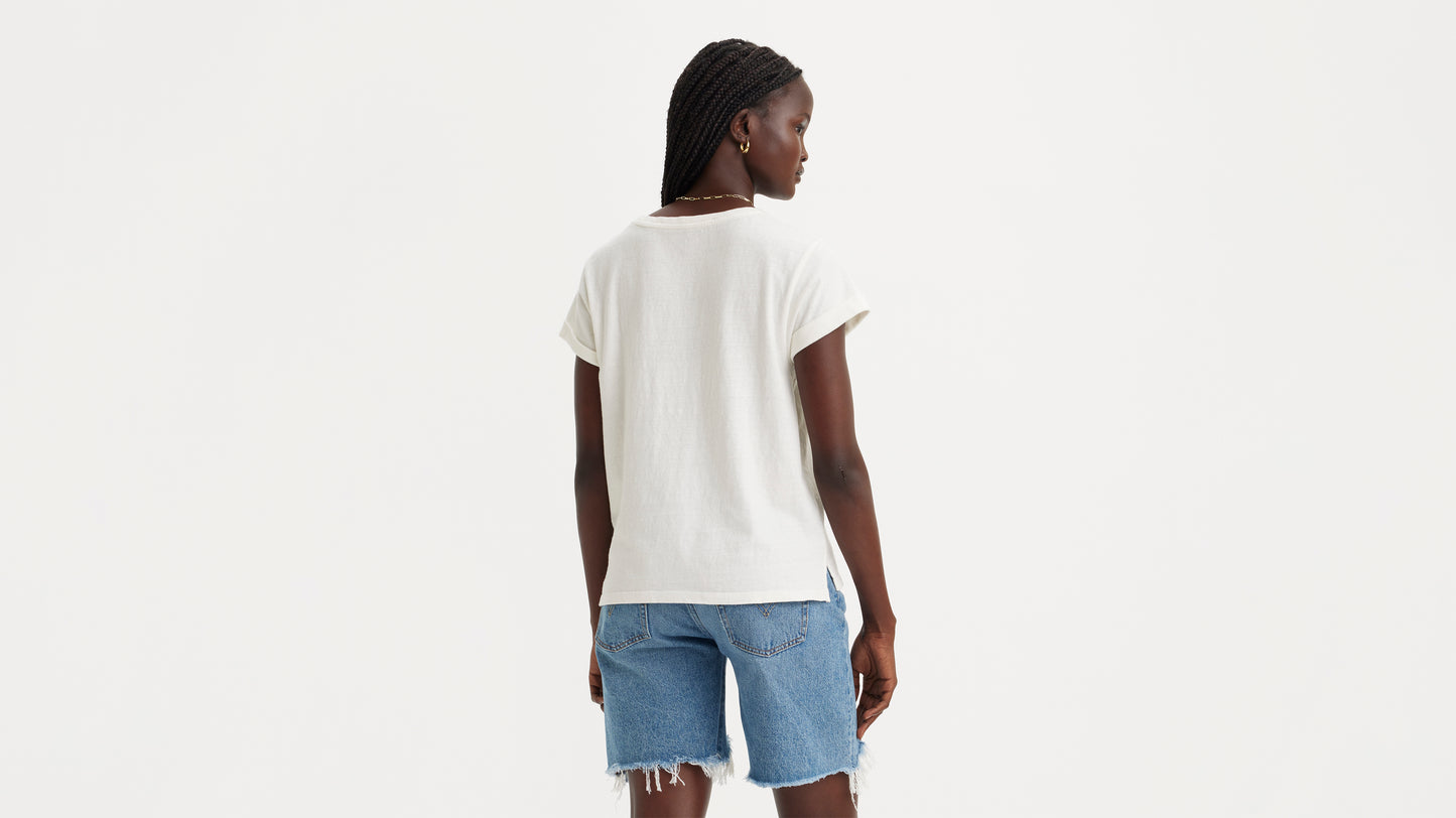 Woman in white shirt and denim shorts, back view