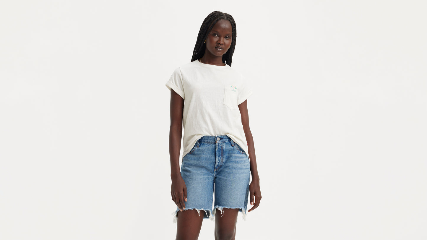 Woman in Levi's white pocket shirt and denim shorts