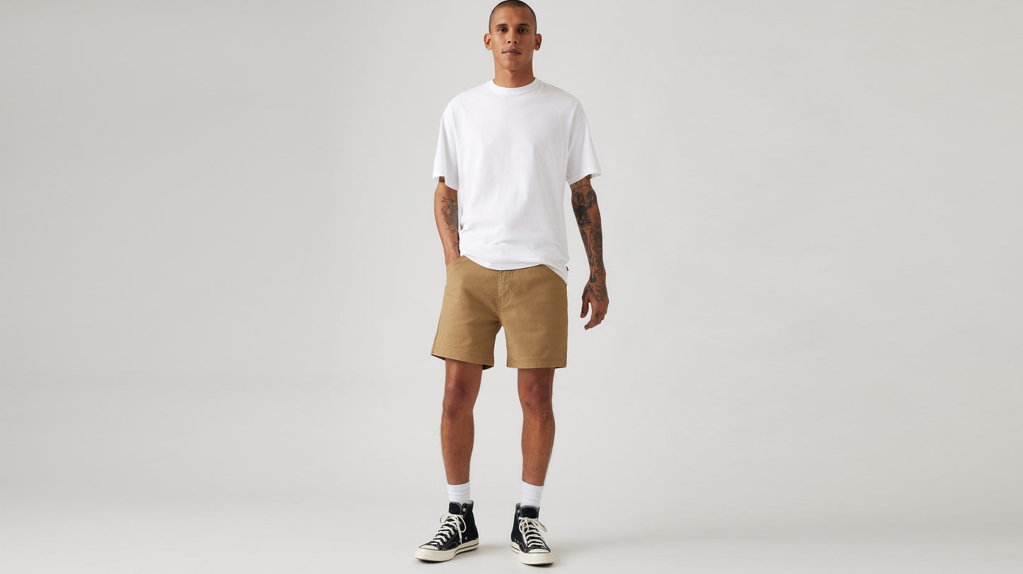 Man in Levi's brown work shorts and white t-shirt