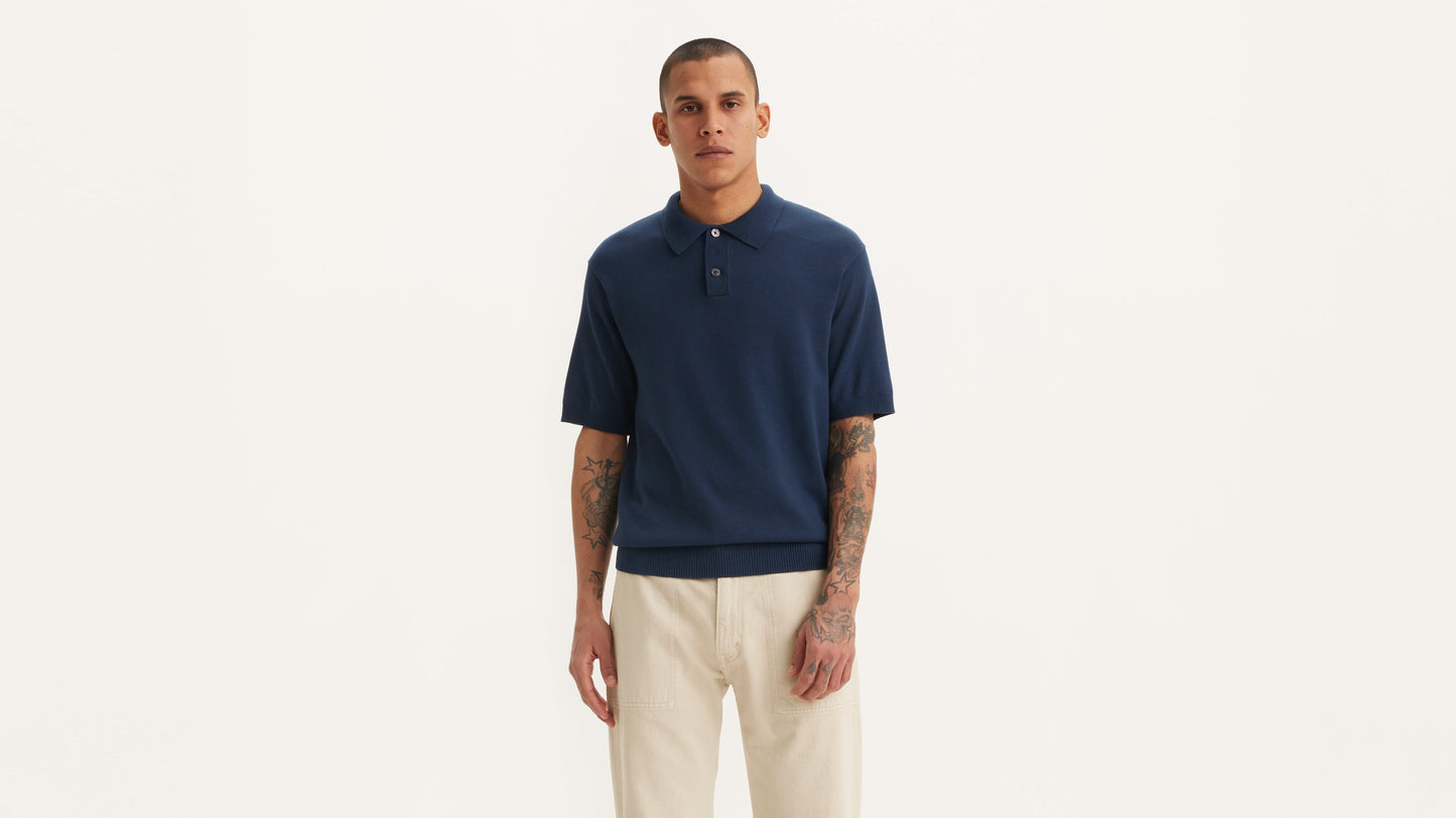 Man in blue Levi's sweater knit polo and beige pants