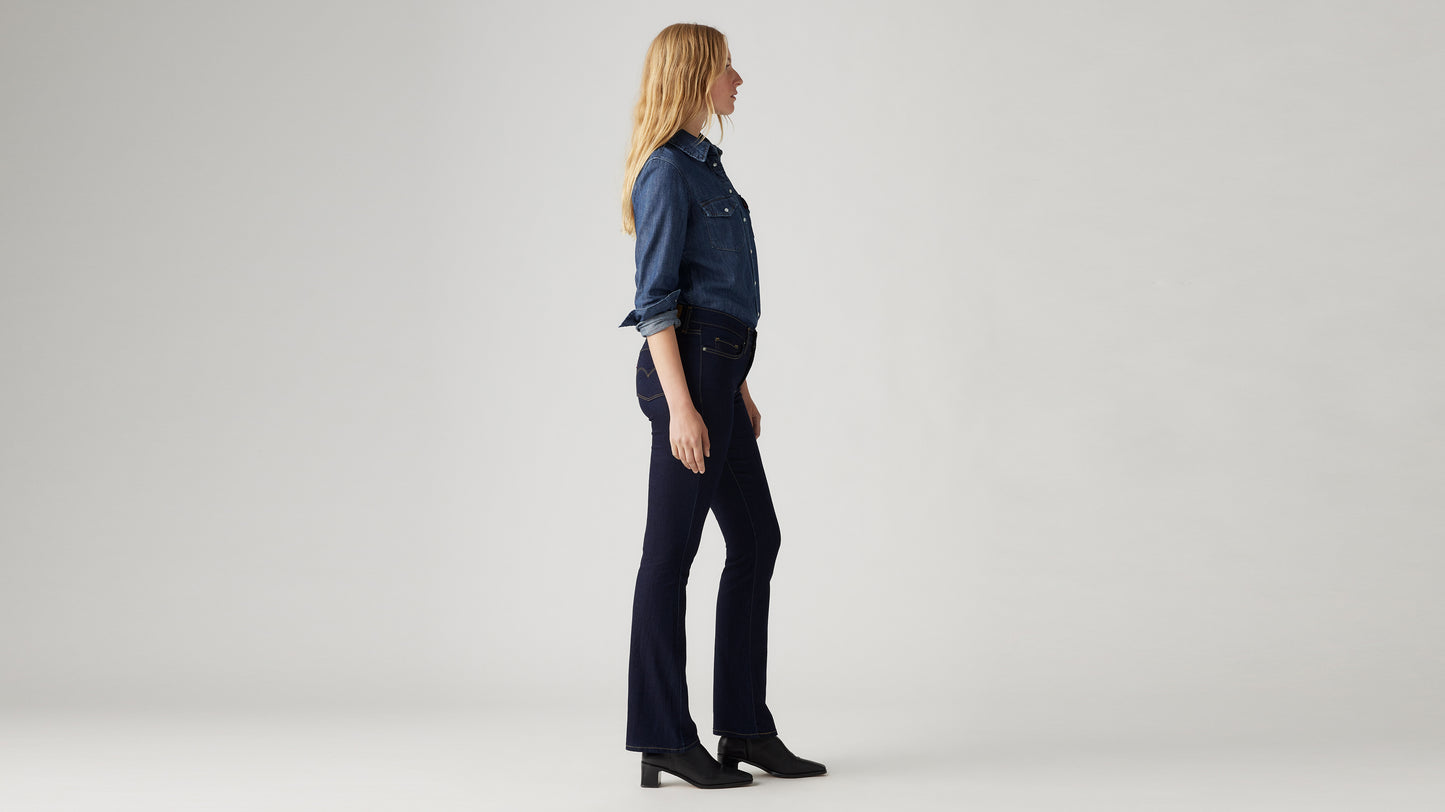 Woman in dark blue bootcut jeans, side view