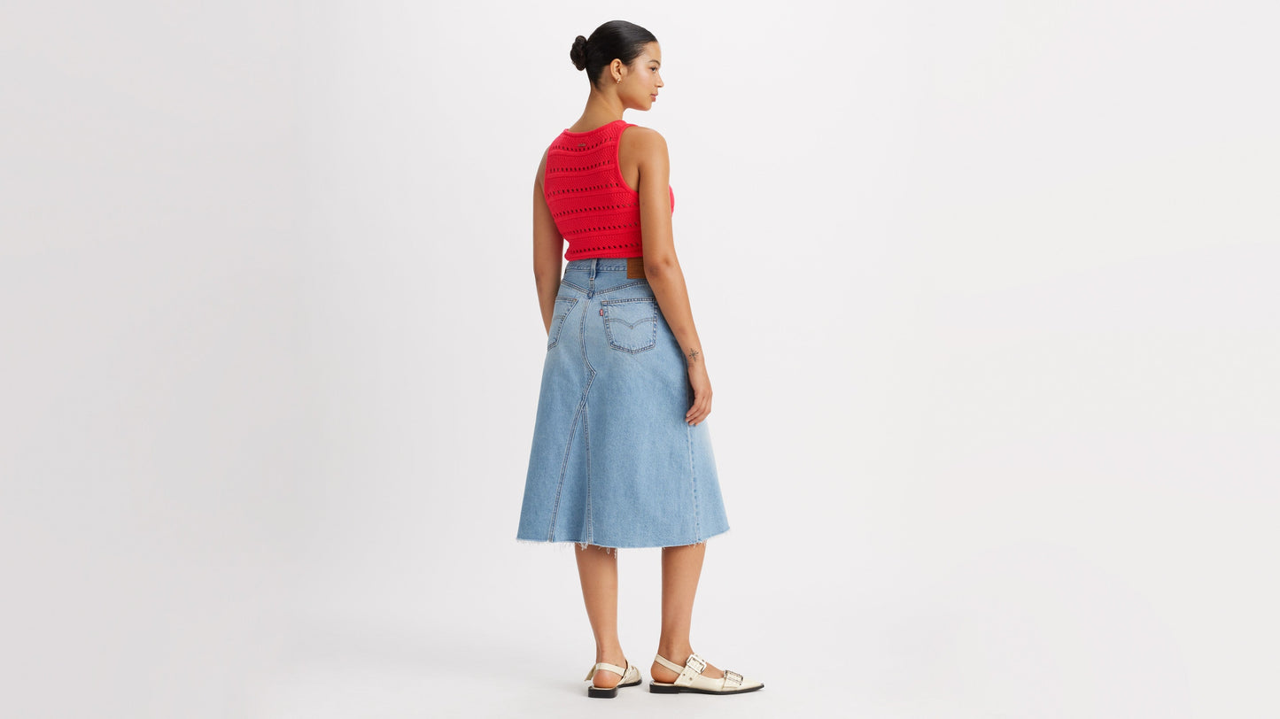 Woman in Levi's high-rise a-line skirt and red top back view