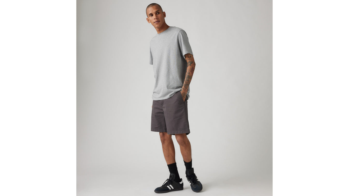 Model in grey tee with charcoal Levi's shorts