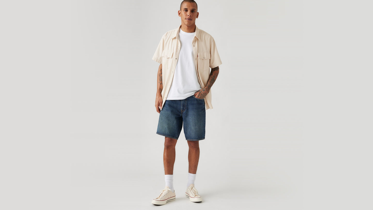 Man in Levi's loose denim shorts with beige shirt
