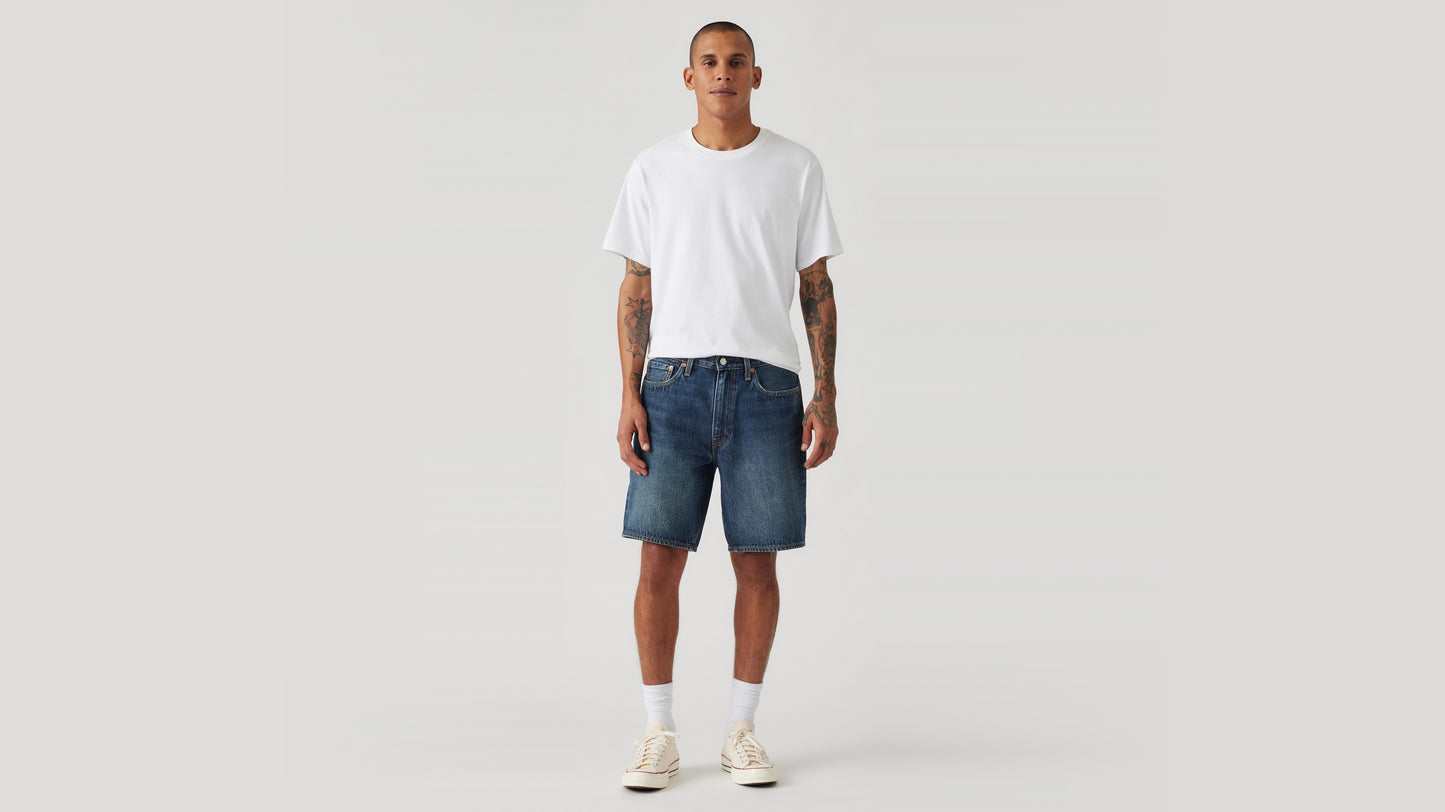 Man wears Levi's denim shorts and white shirts