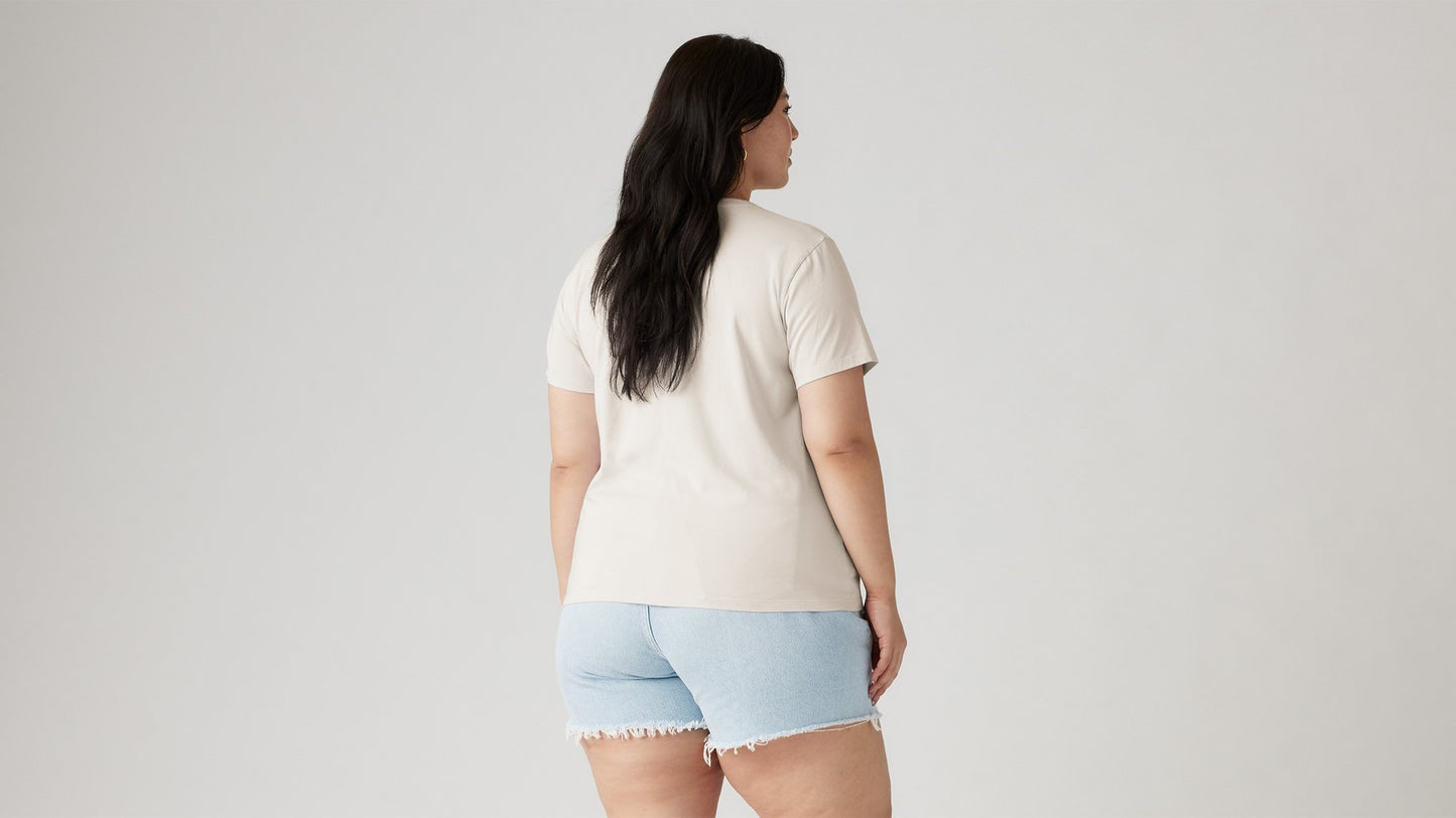 Woman in off-white tee and blue ripped shorts