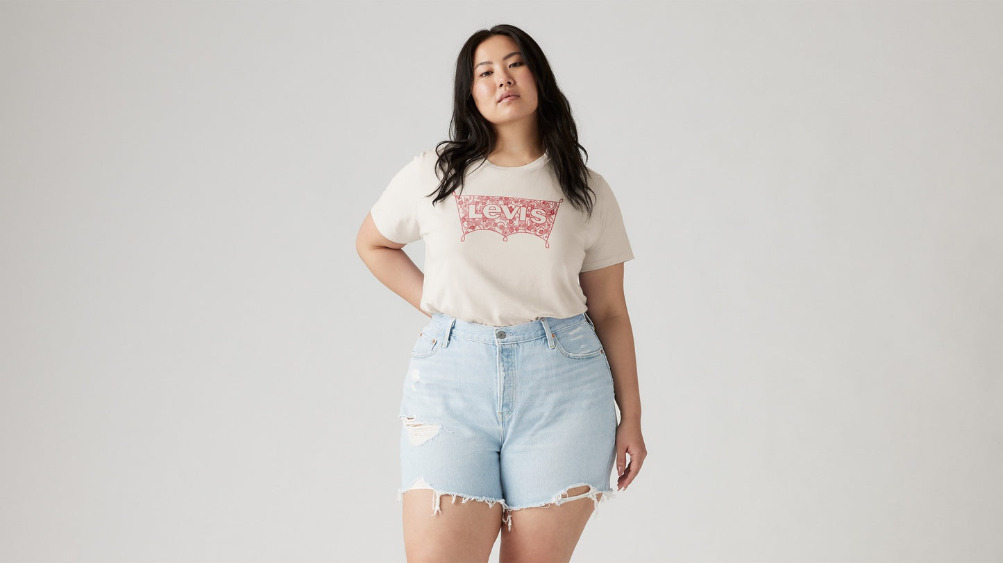 Woman in off-white Levi's graphic tee and blue ripped shorts