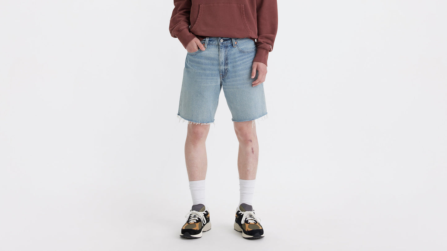 Cropped front view of man in Levi’s 468 loose Shorts in light wash with sneakers