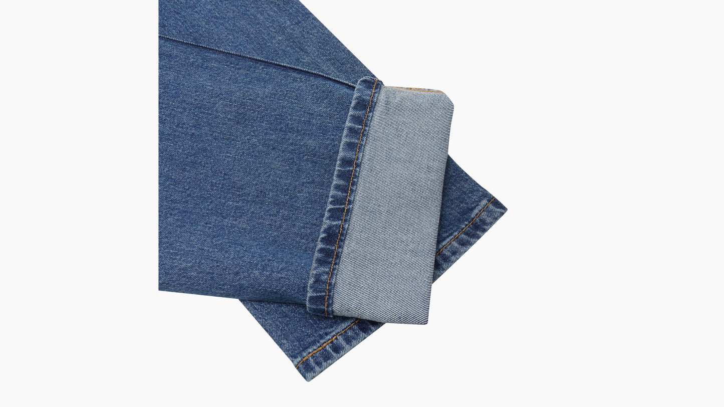 Cuffed hem detail of Levi’s 511 slim jeans in classic medium blue denim finish