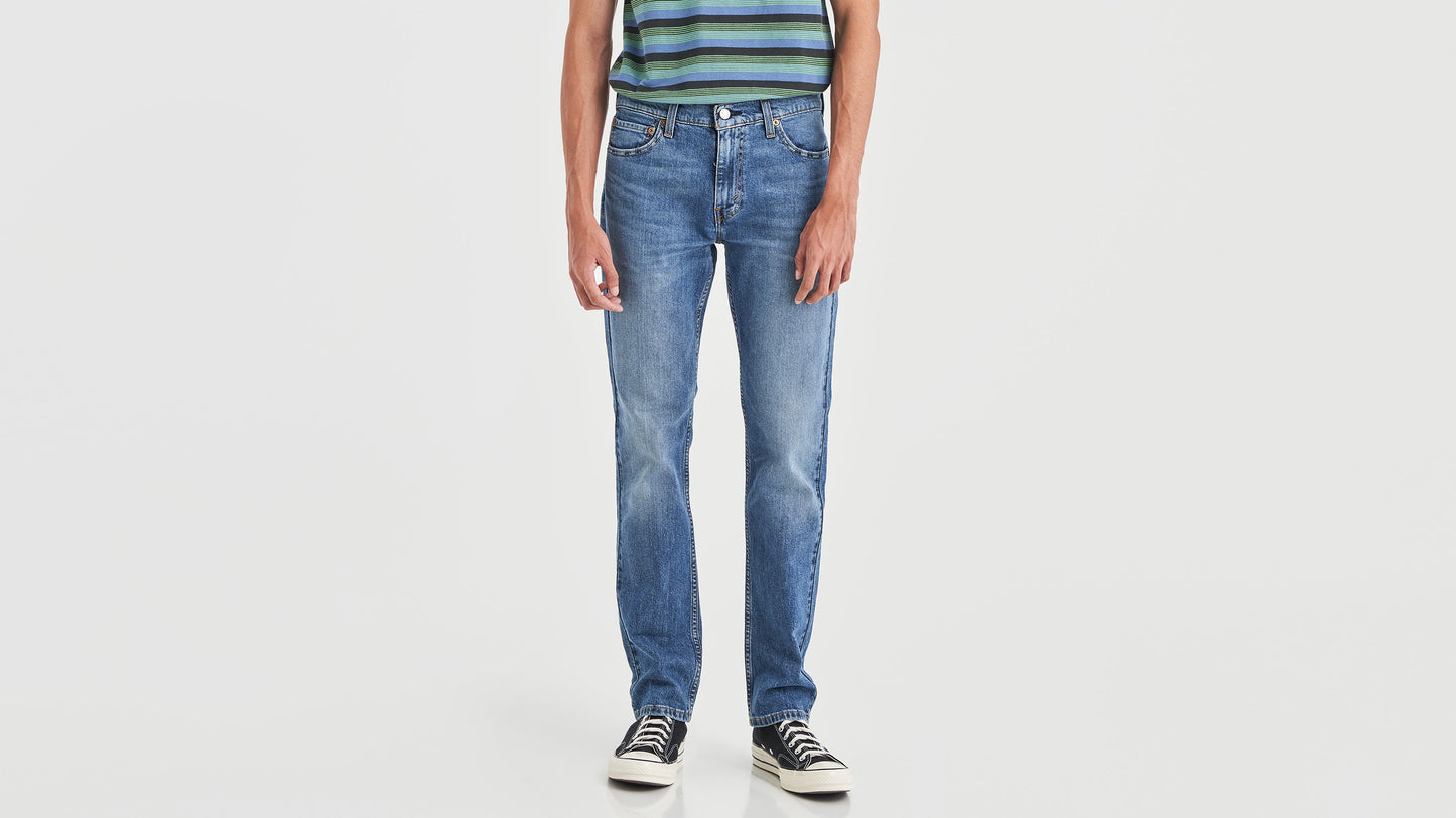Cropped-view of a man in striped green polo shirt, blue Levi’s 511 jeans