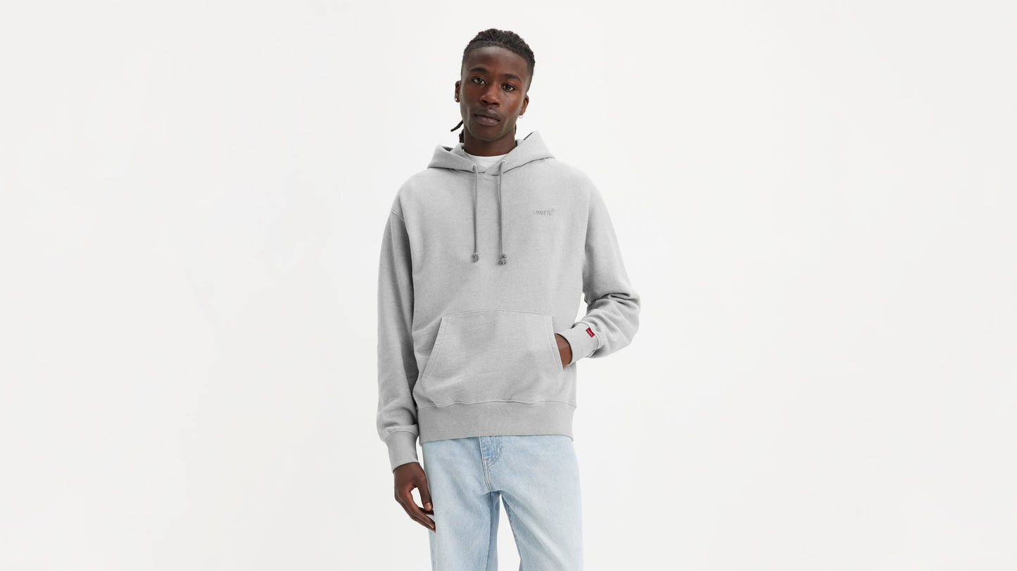 Man in grey Levi's Men's Authentic Hoodie with light wash jeans facing forward