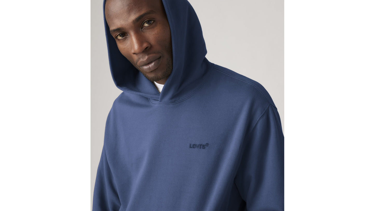 Close-up of model in navy Levi's hoodie with logo embroidery
