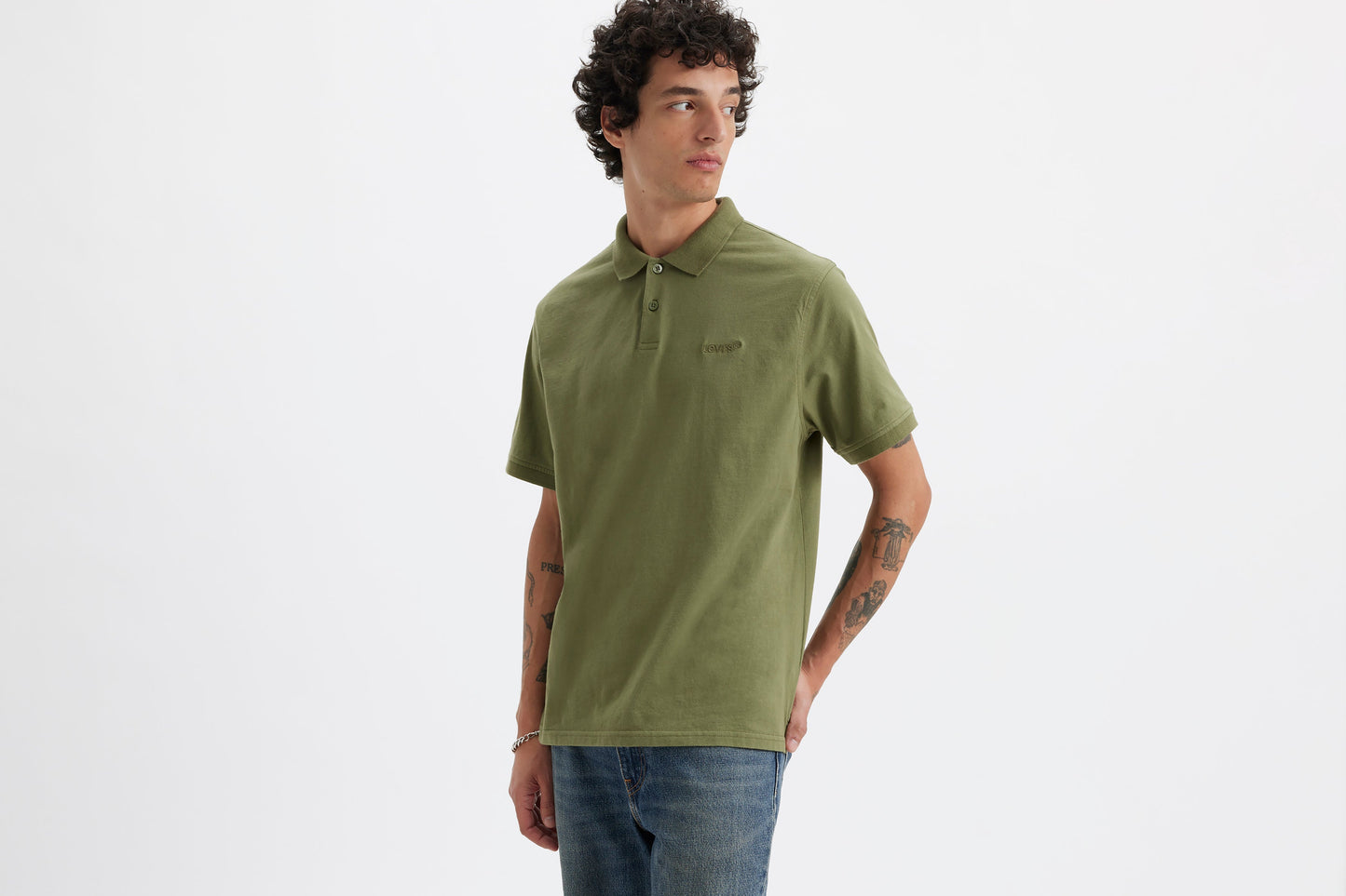 Model wearing classic olive Levi's polo and jeans