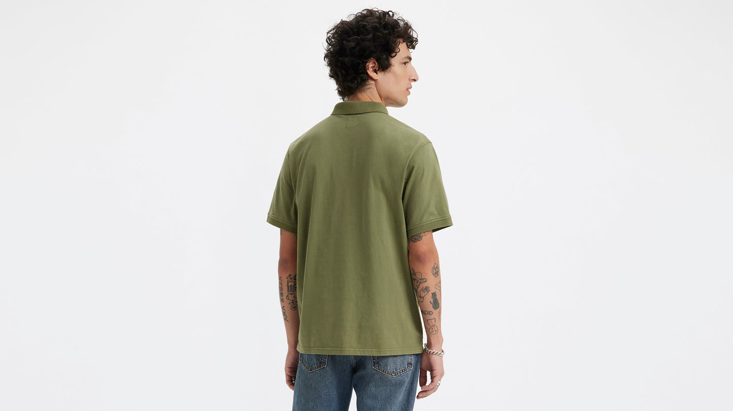 Back view of man in olive green Levi's polo and jeans