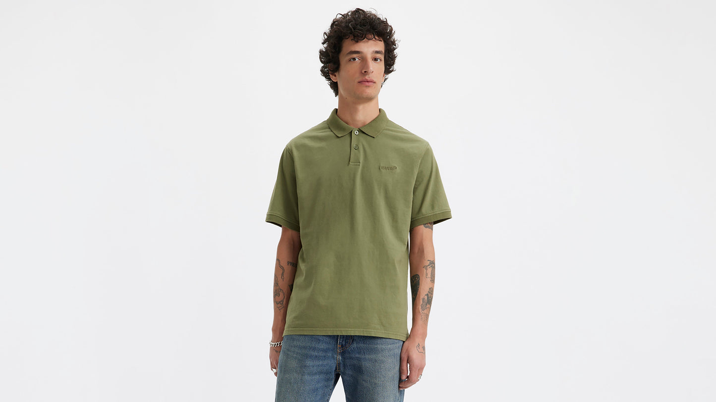 Model in short sleeve green Levi's polo and jeans