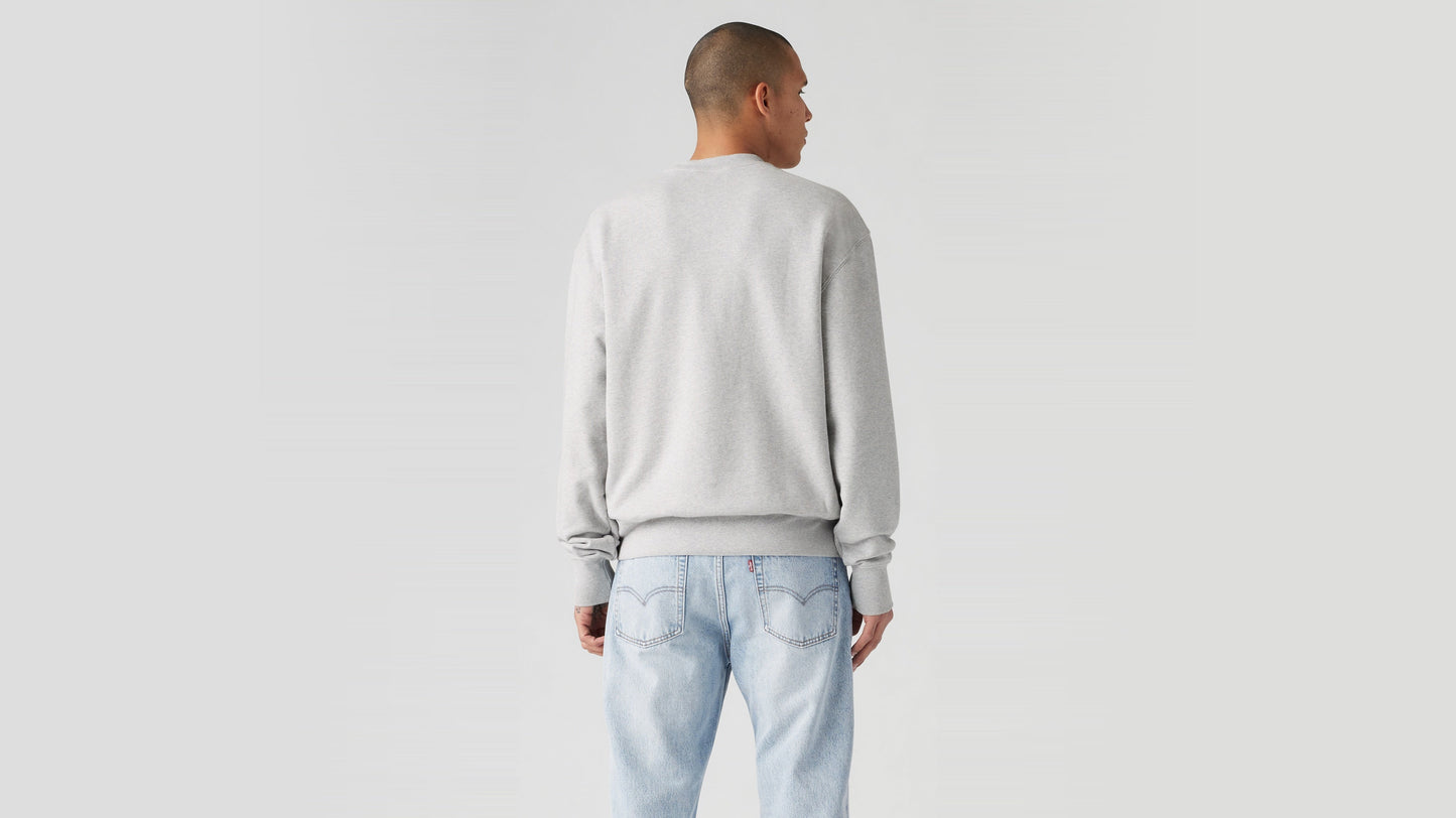Model facing away in pale jeans and grey pullover