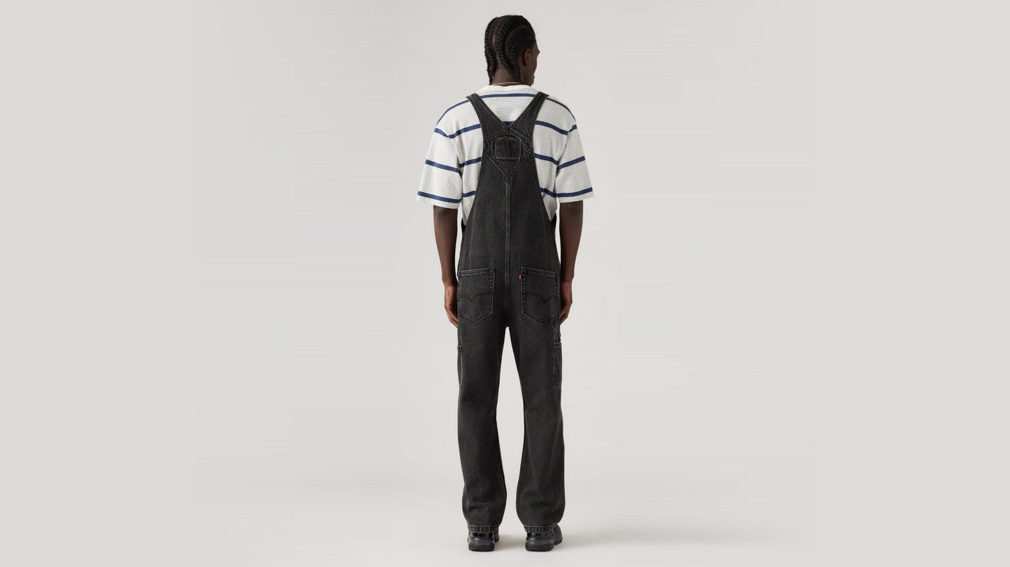 Back view of man wearing black Levi's men's red tab overalls