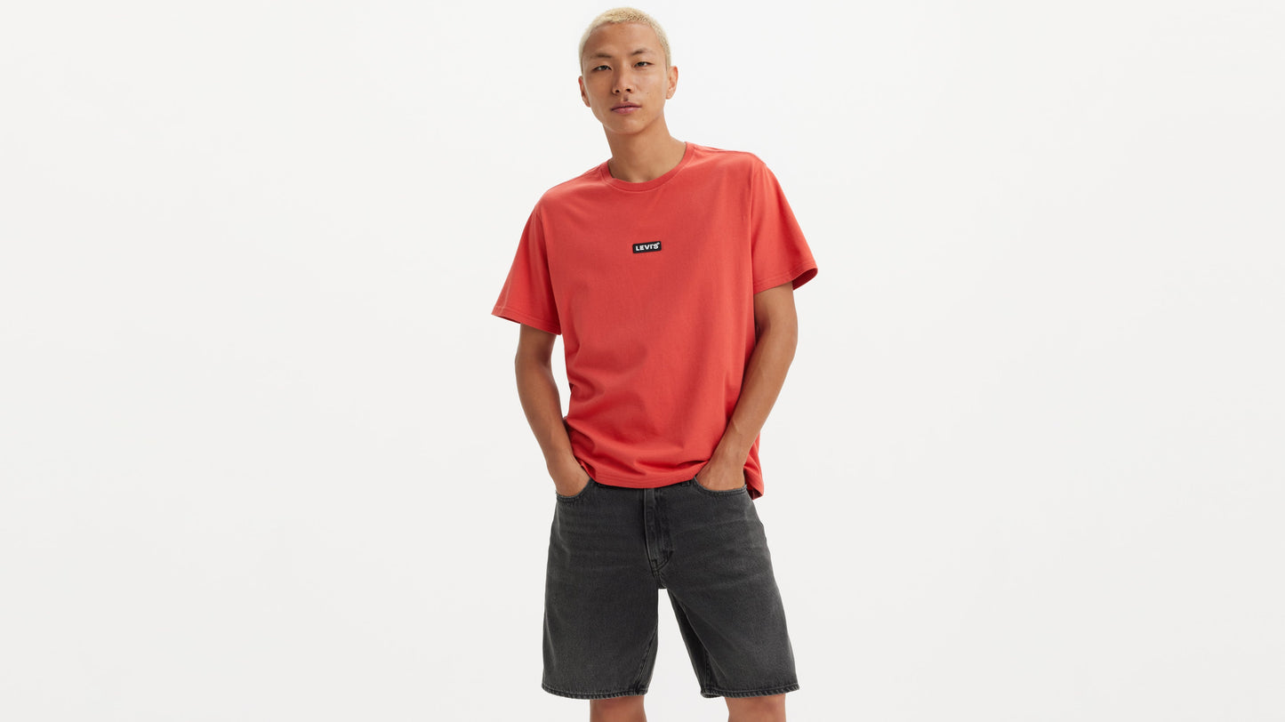 Man in red Levi’s tee and black shorts, front view with logo