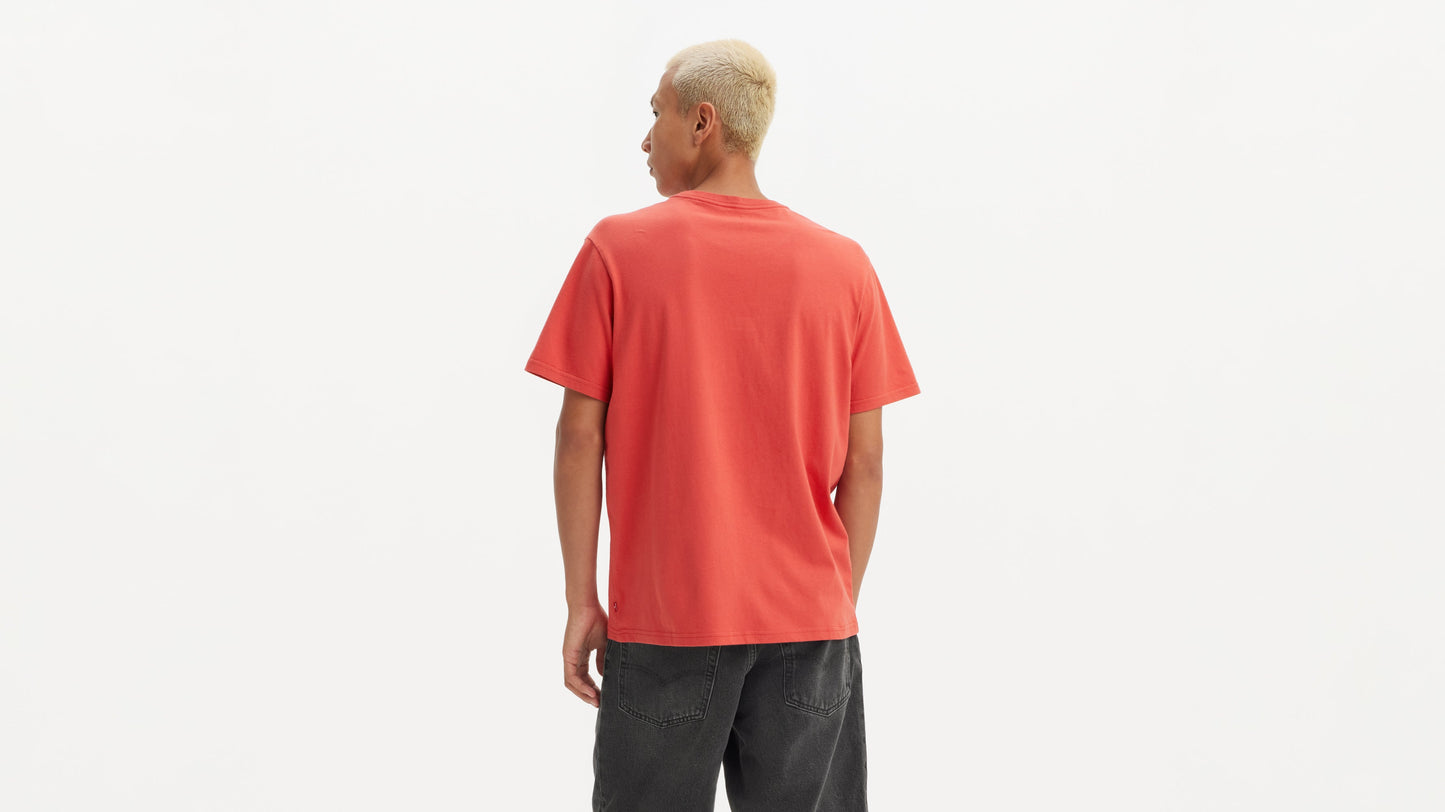 Back view of man in red Levi’s tee and faded black shorts