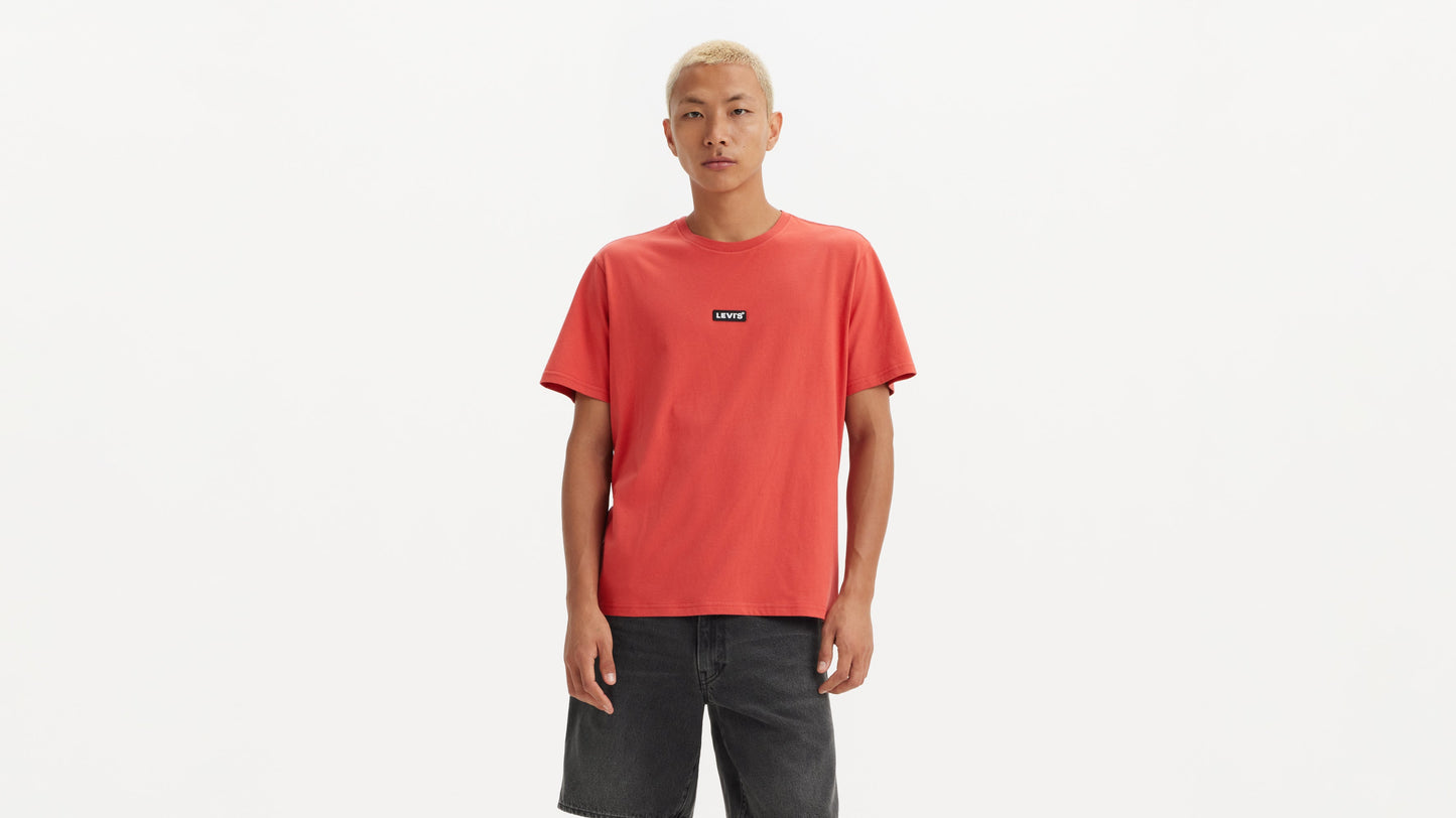 Male model in red Levi’s T-shirt and dark shorts