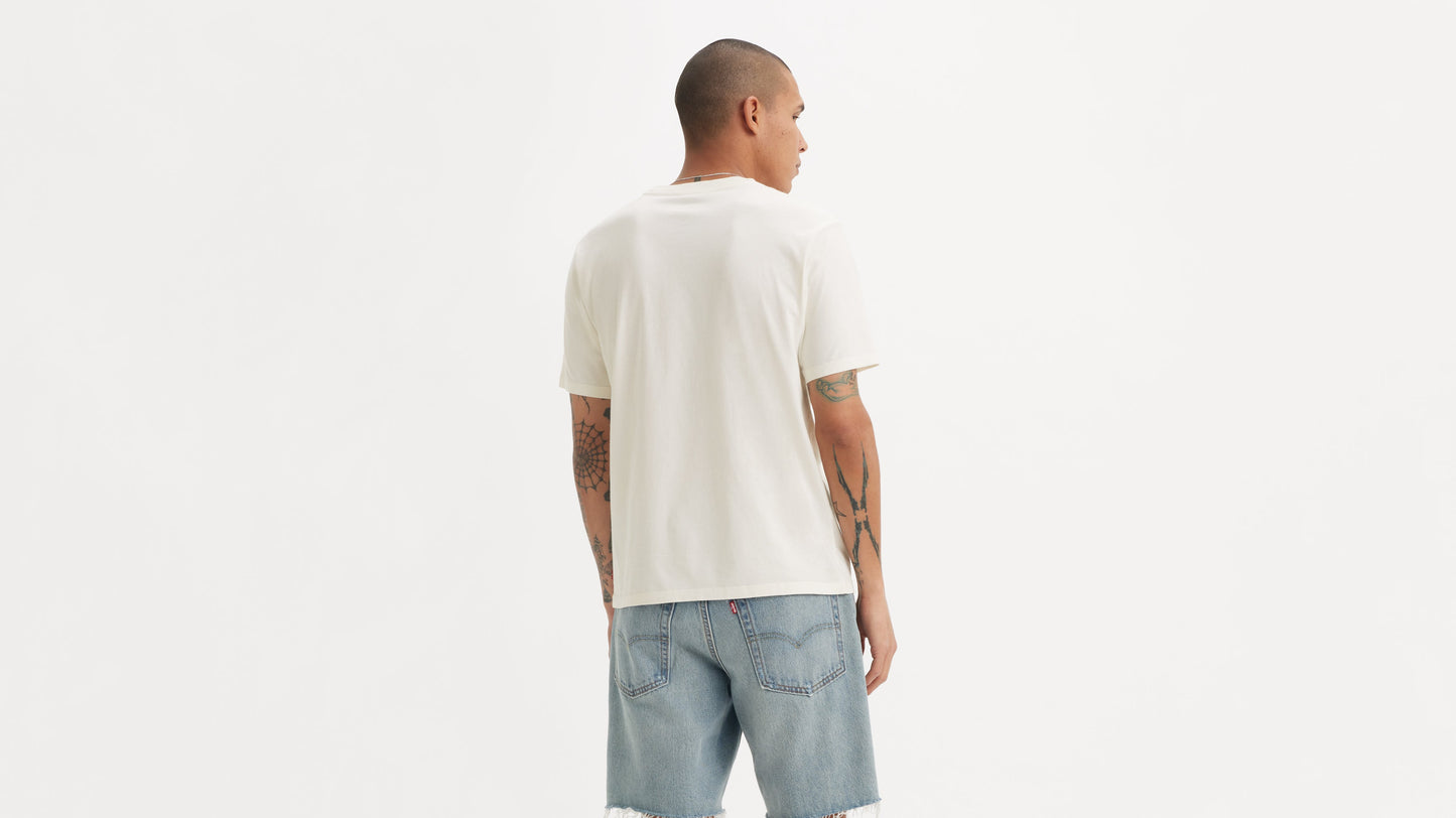 Back view of man in white tee and cut-off shorts