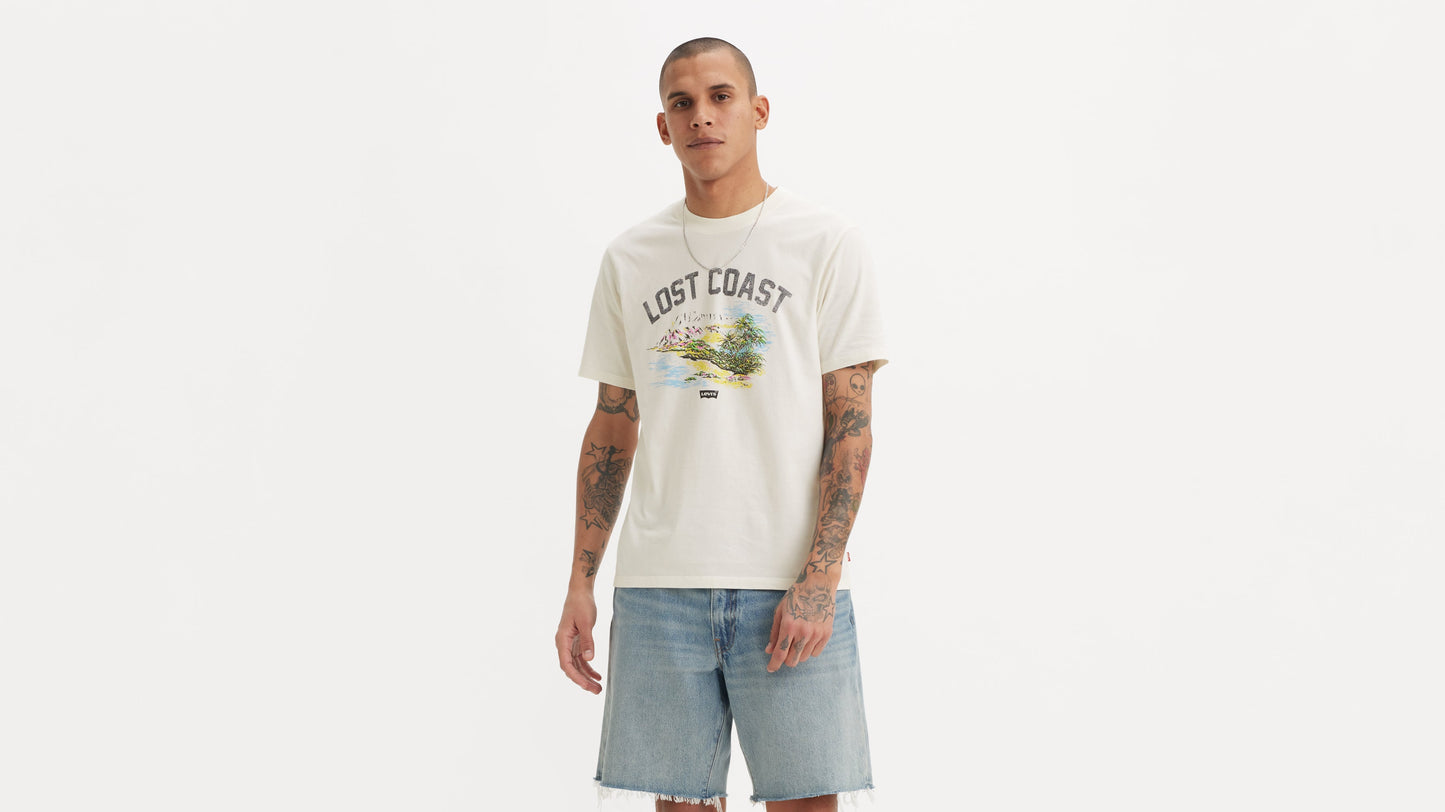 Man wearing white printed t-shirt and cutoff shorts