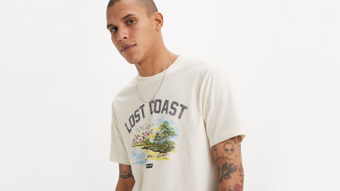 Model in white graphic tee with tropical print