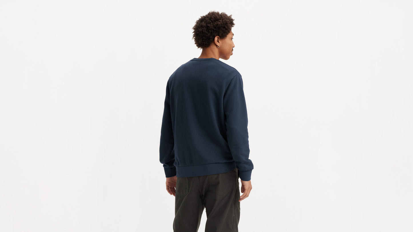 Model wearing dark Levi’s top and utility trousers, back facing