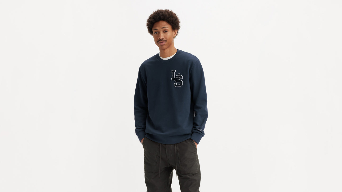 Man in navy Levi’s sweatshirt and cargo pants