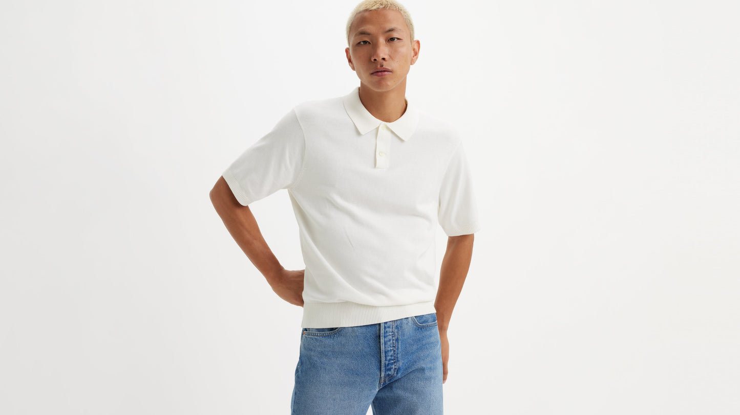 Model in white Levi's knit polo shirt & blue jeans, front view