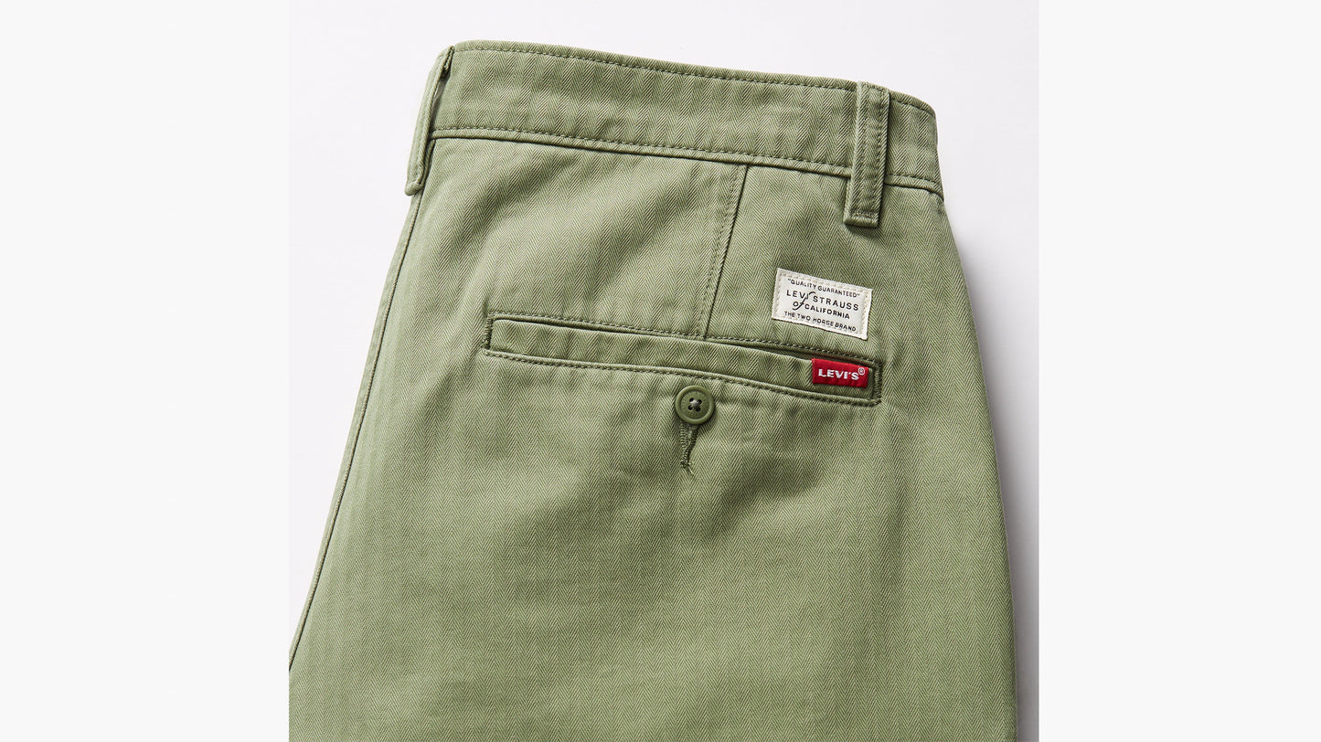 Rear view of green Levi’s chino pants with back pocket, button, and labels