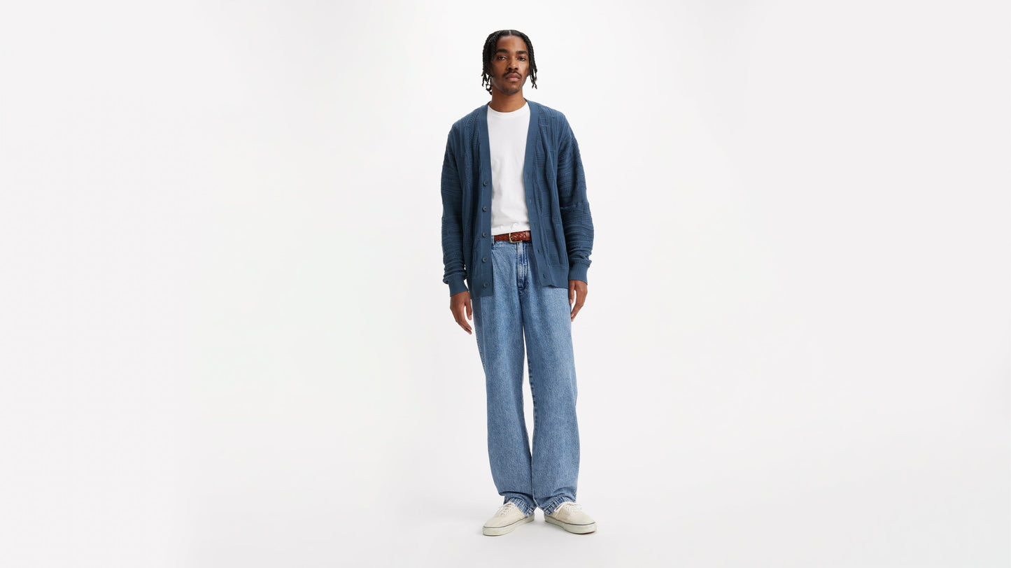 Male in blue knit cardigan, light-wash jeans, white tee and Levi’s belt, front view