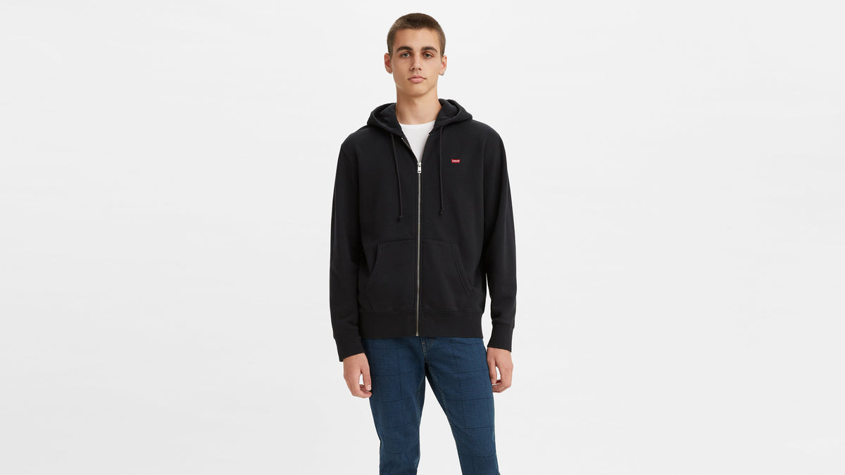 Front view of man wearing Levi's black zip-up hoodie with Levi’s logo