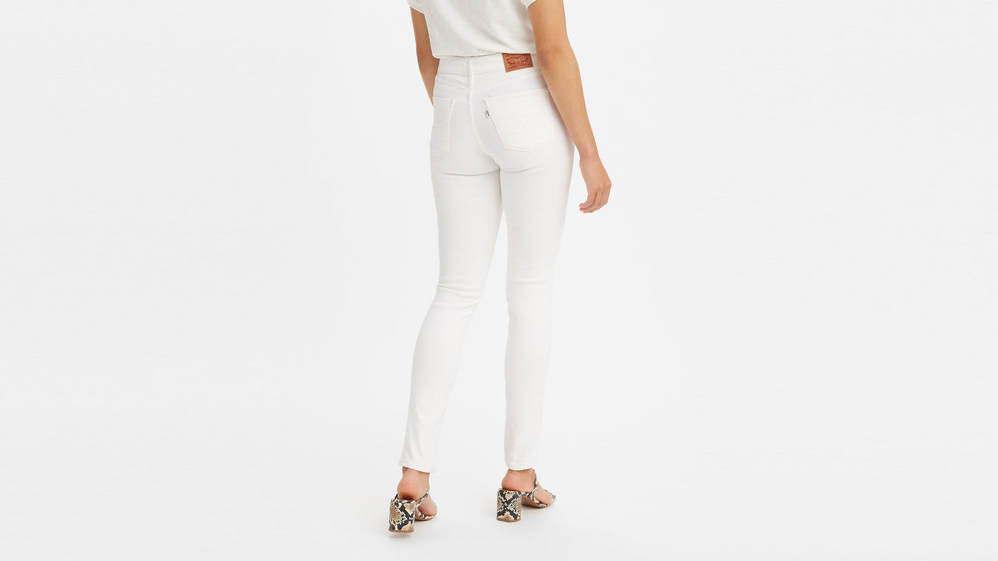 Rear view of woman in Levi’s 311 Shaping Skinny Jeans and snake-print heels