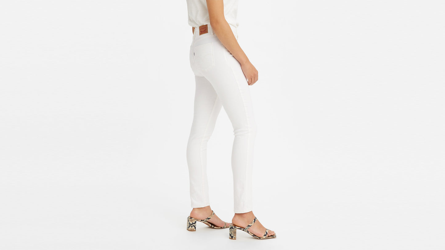 Side view of woman in Levi’s 311 Shaping Skinny Jeans and snake-print heels
