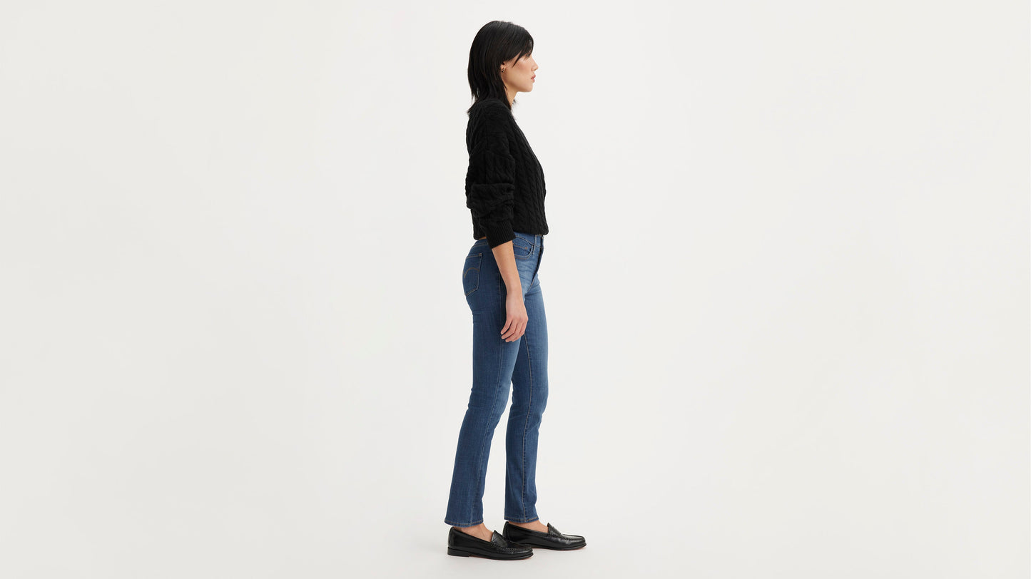 Levi’s 312 Shaping Slim Jeans in blue, worn with black sweater and loafers, side view