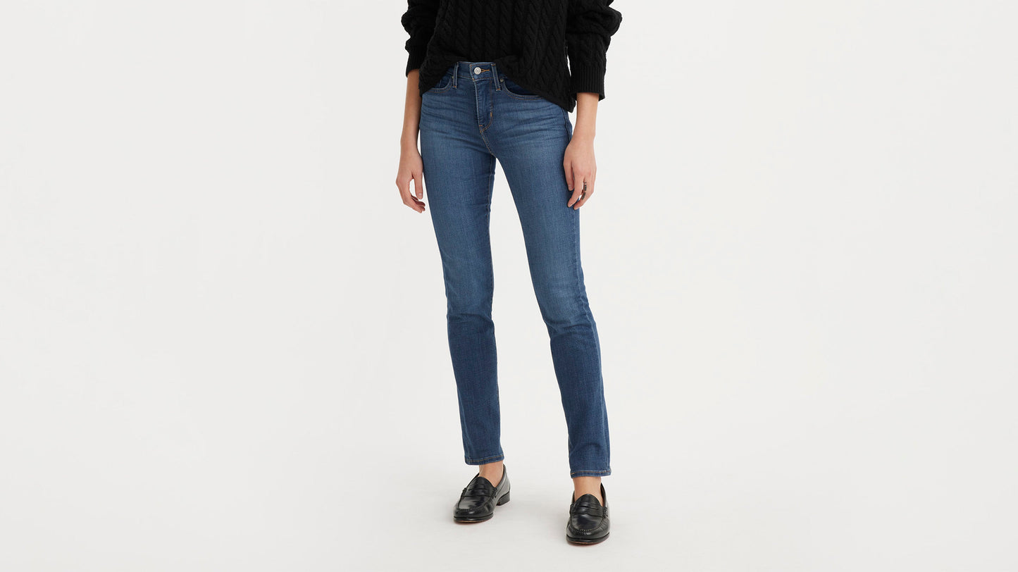 Woman wearing Levi’s 312 Shaping Slim Jeans in blue, front view with black sweater & loafers