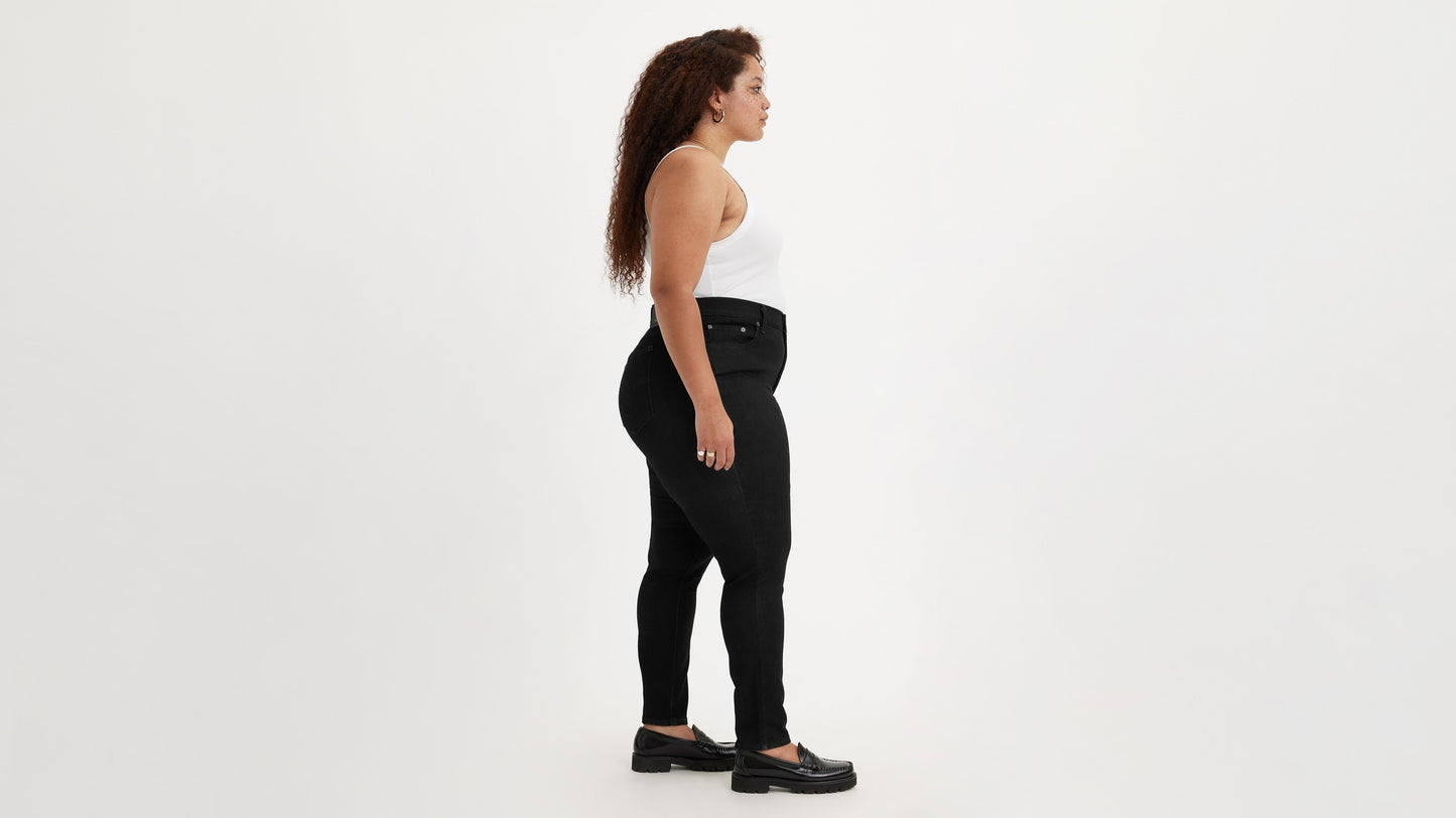 Side view of woman in Levi's high rise plus size skinny jeans