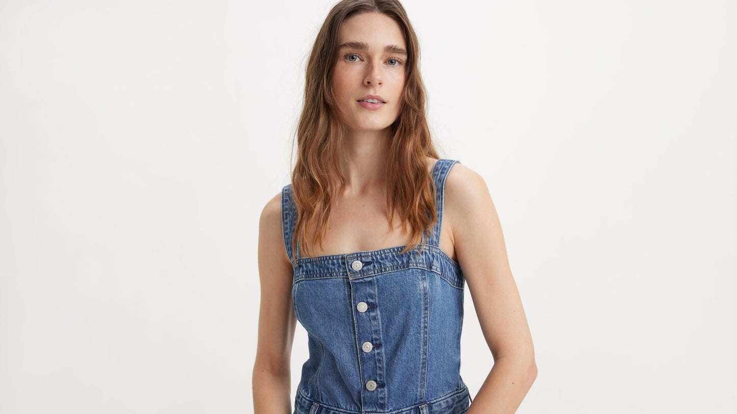 Woman wearing denim jumpsuit, upper-body view