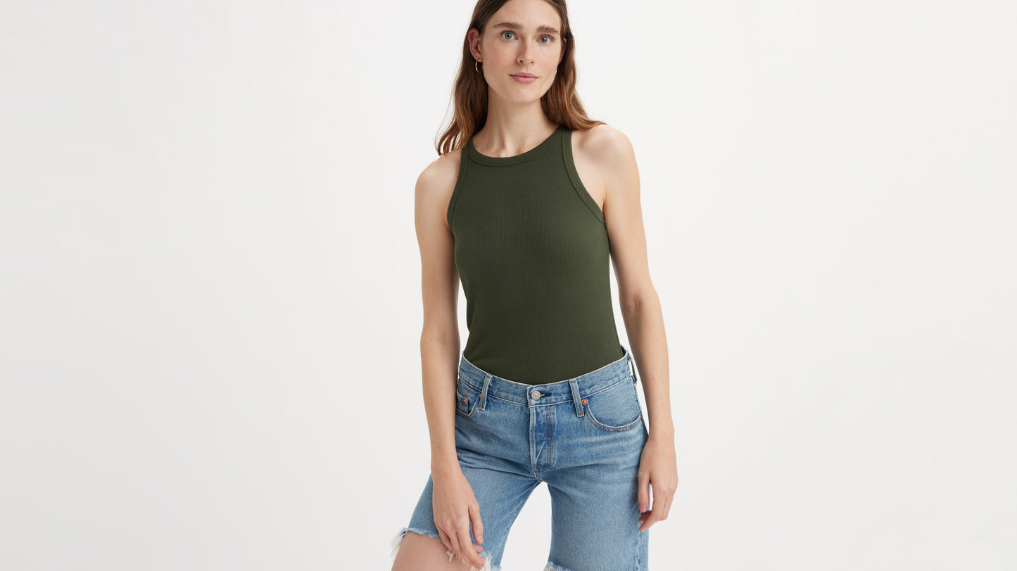 Woman in olive green racer tank and denim shorts