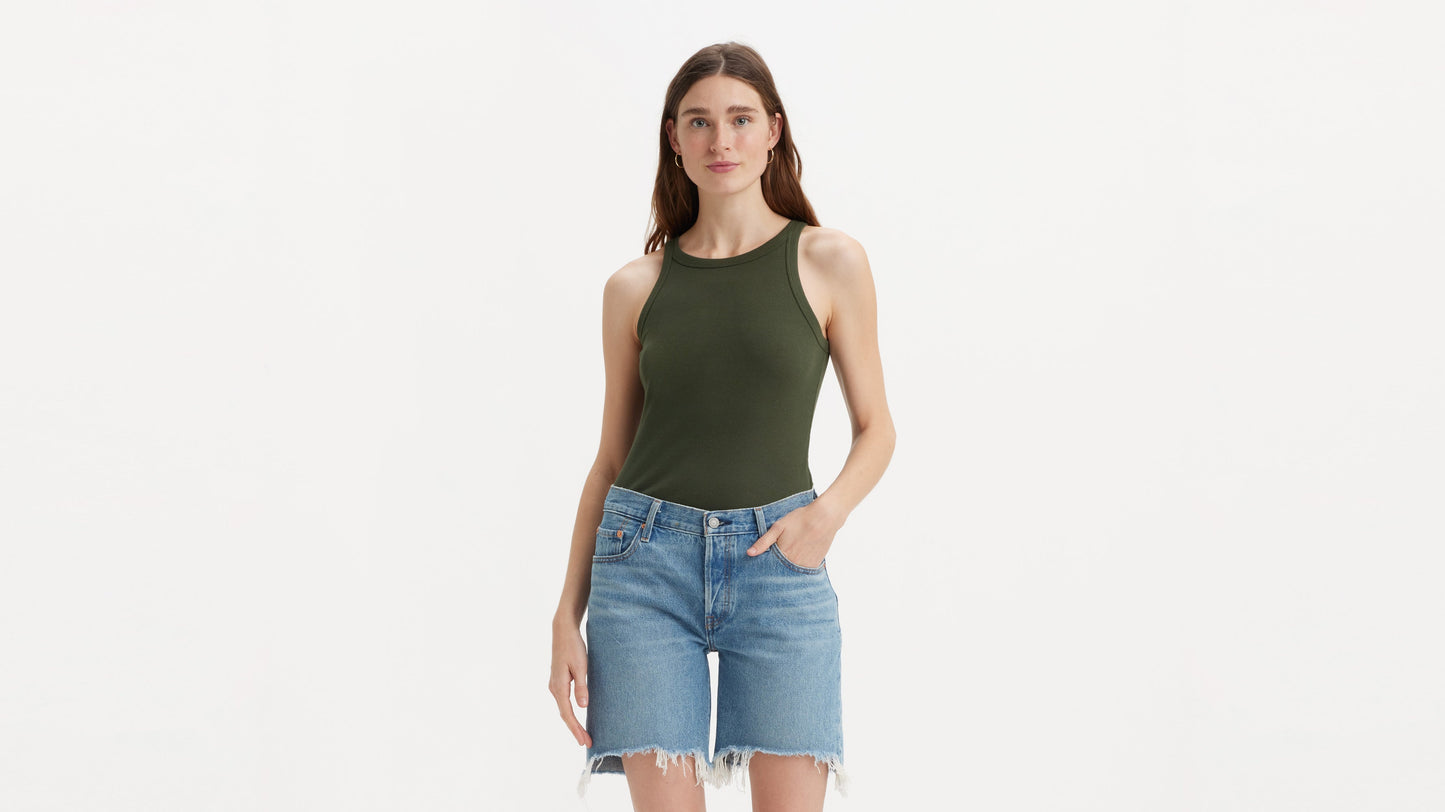 Woman in Levi’s light denim shorts and olive tank