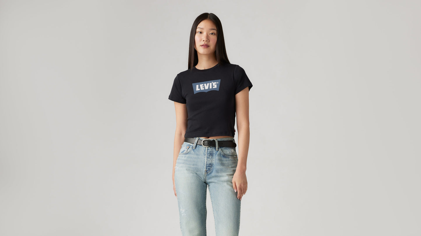 Woman in light Levi's jeans and cropped black graphic tee