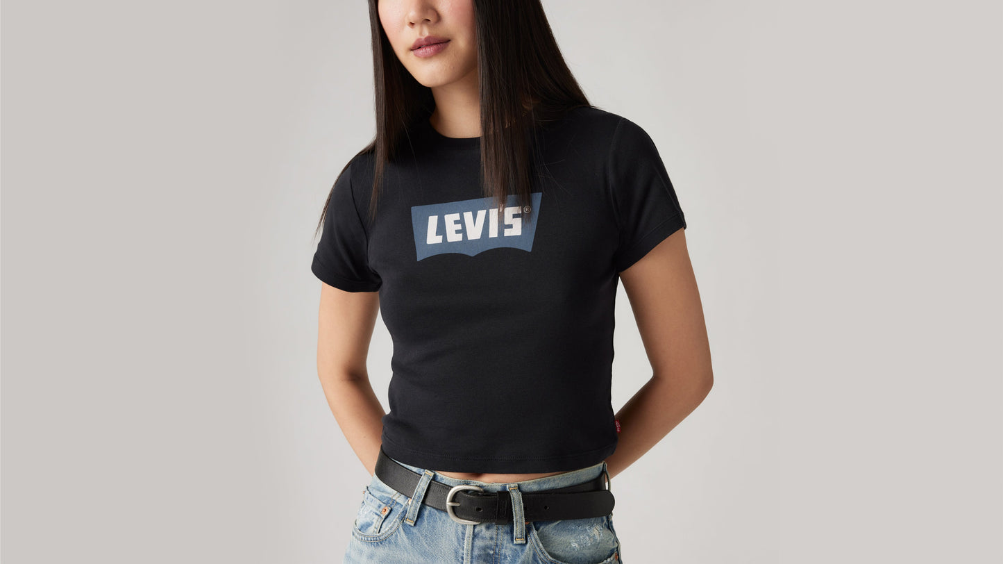 Close-up of woman in black Levi’s tee and light denim jeans