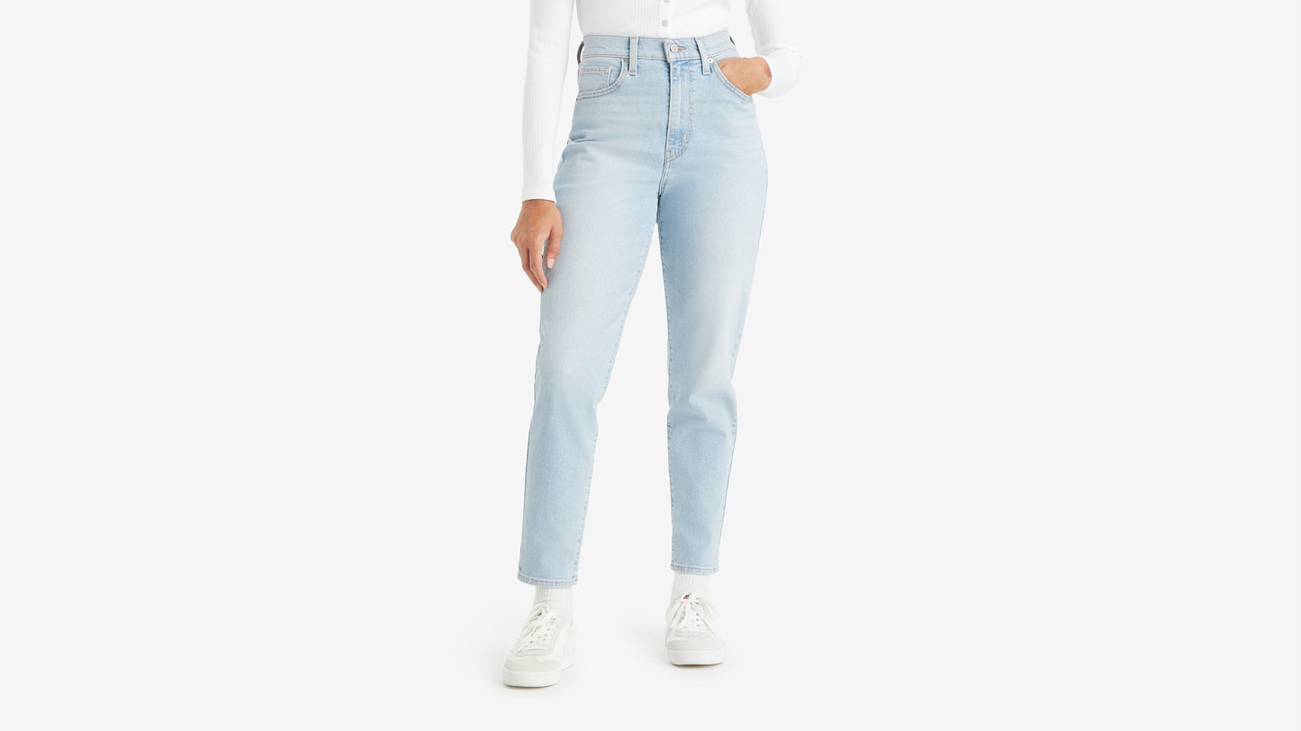 Cropped front view of a woman in high-waisted mom jeans in light wash