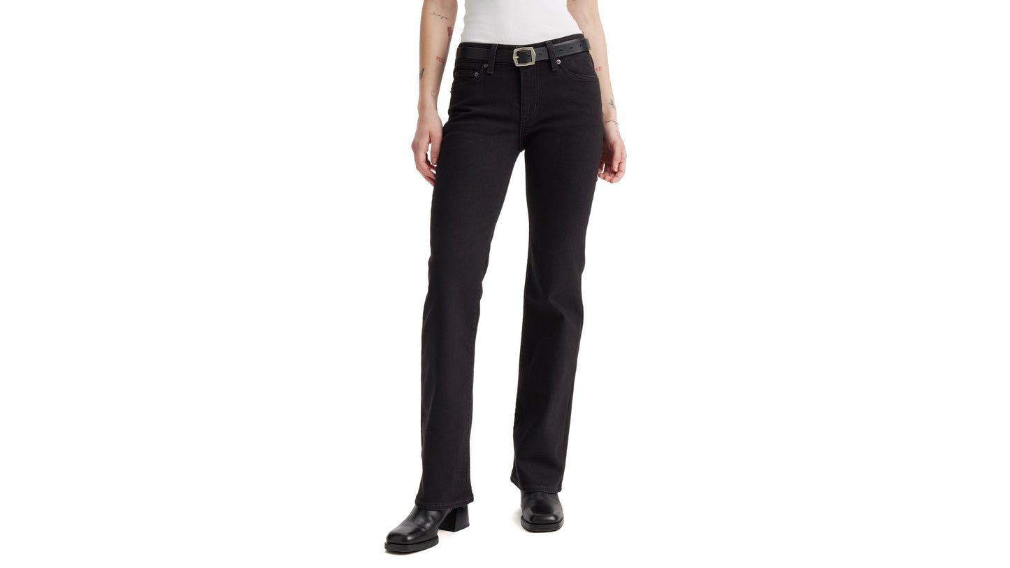 Close-up front view of Levi's Superlow Bootcut Jeans with black belt and boots