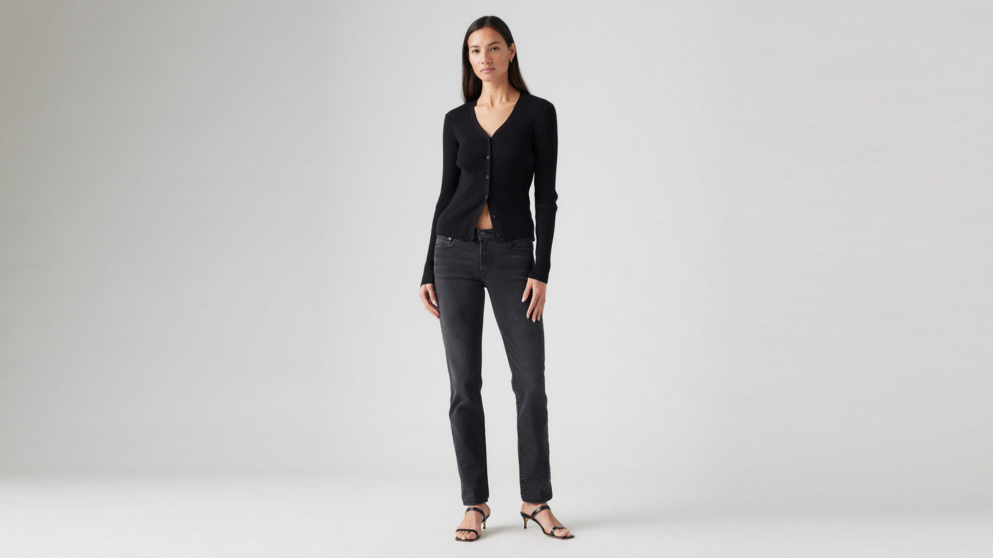 Front view of model in black Levi’s superlow skinny jeans & ribbed cardigan
