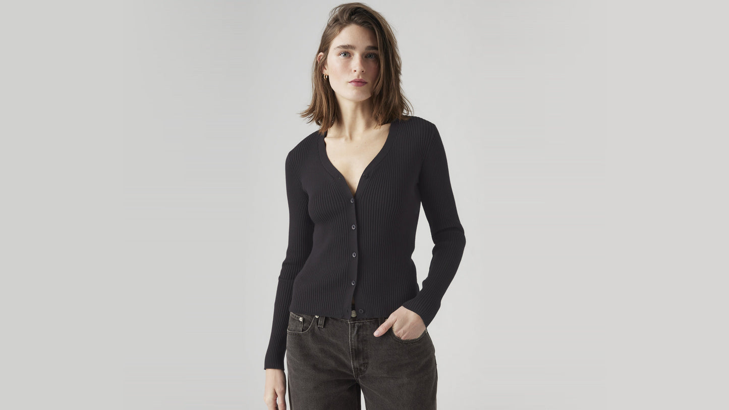Woman in black V-neck cardigan and dark pants