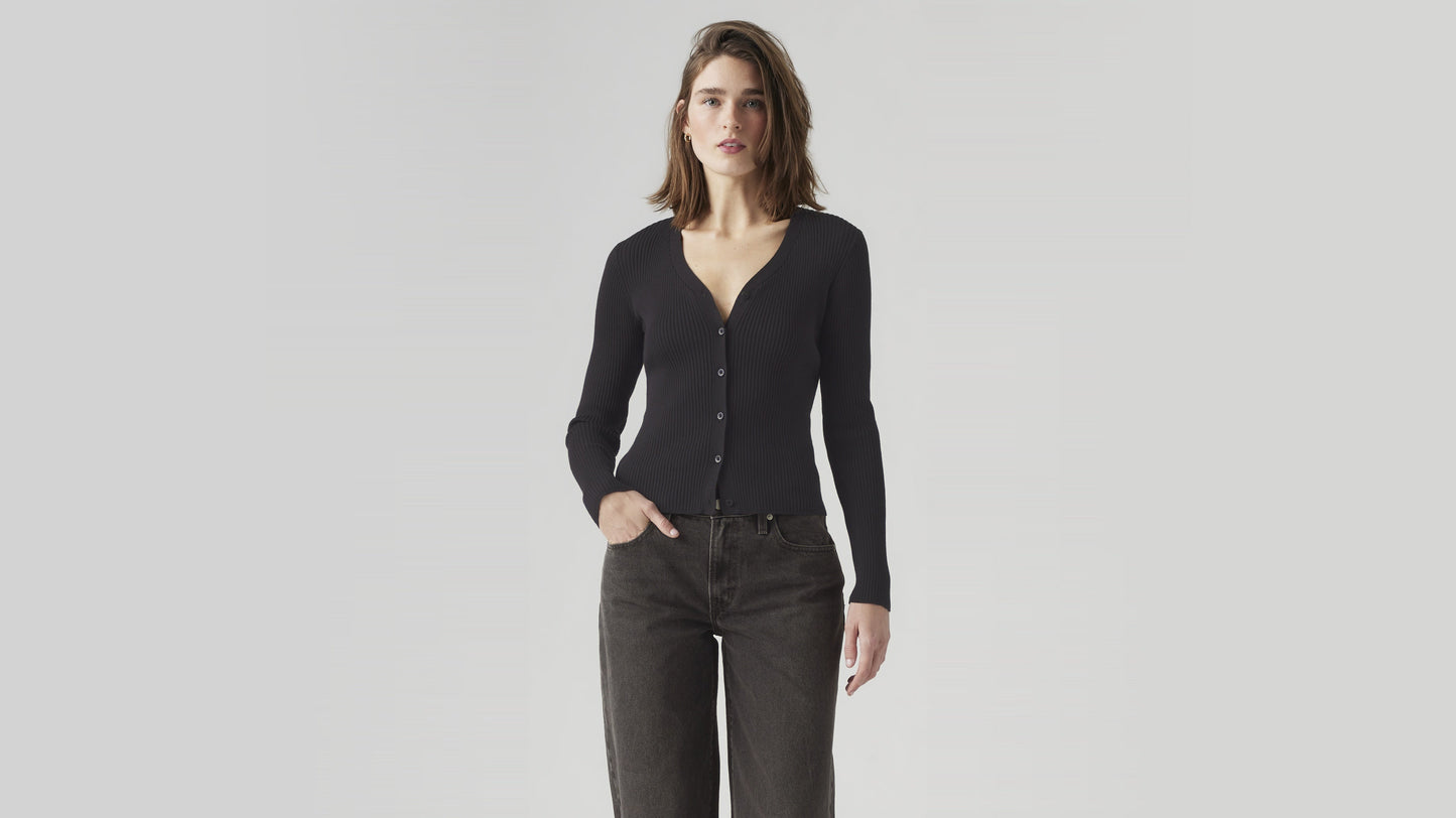 Woman wearing black Levi’s cardigan and dark jeans