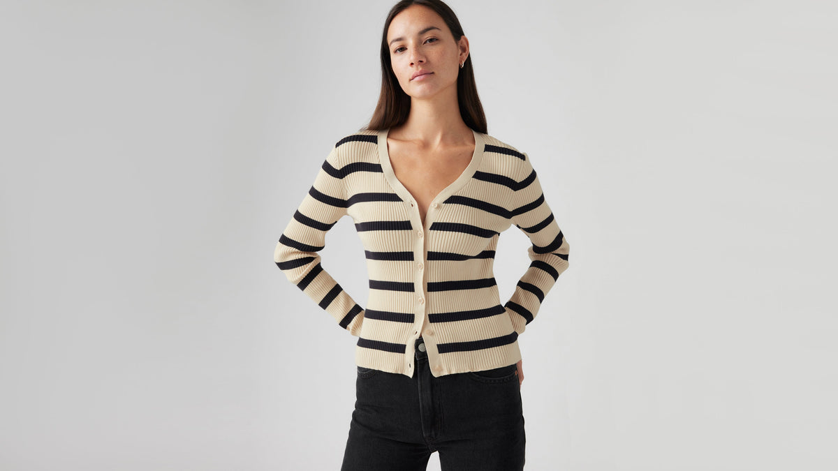 Woman in striped Levi’s cardigan and black jeans