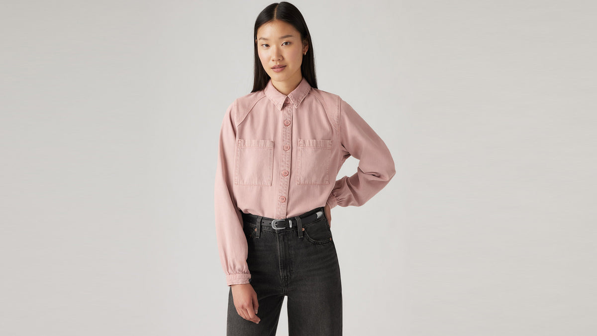 Model wearing pale rose Levi’s button-up shirt with front pockets